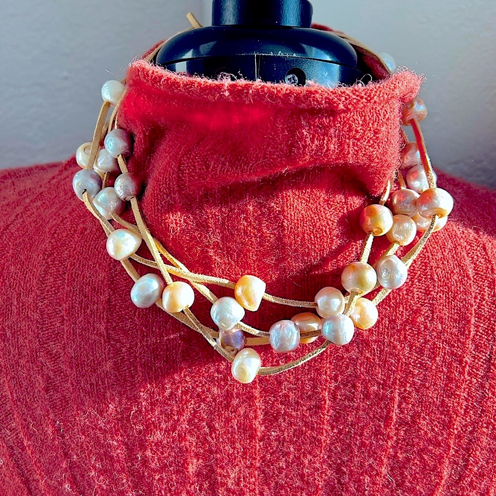Three strand multi-colored fresh water pearls on leather. Collar bone length.